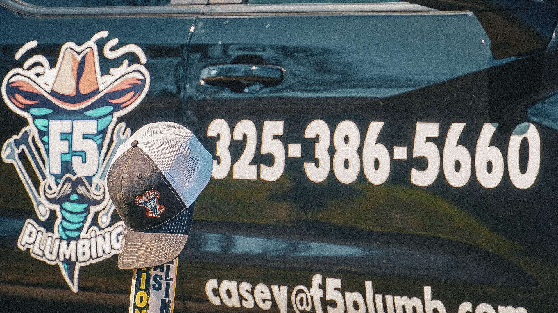 F5 Plumbing truck displaying the company logo and phone number