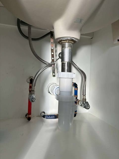 Clean under-sink drain and shutoff plumbing installation