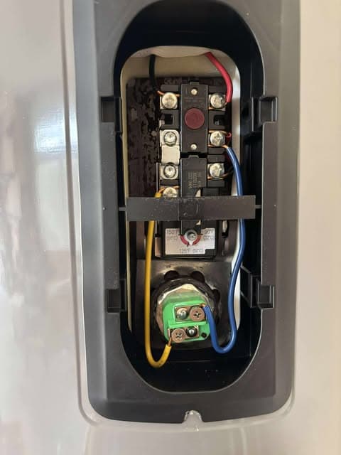 Open electric water heater control panel during service